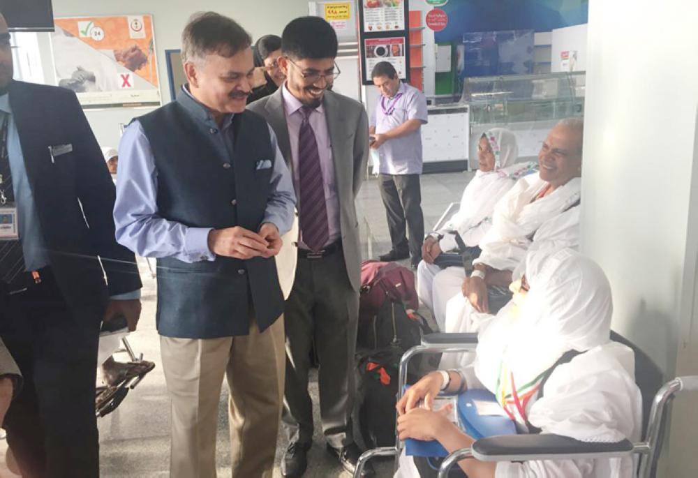 Ahmad Javed Ambassador of India (left), and Md. Noor Rahman Sheikh Consul General of India (behind him), welcome pilgrims on their arrival in the Kingdom. — Courtesy photo
