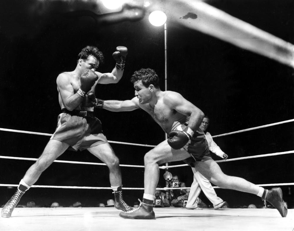 This June 16, 1949, file photo, shows Jake LaMotta (R) fighting Marcel Cerdan in Briggs Stadium in Detroit. LaMotta knocked out Cerdan in the tenth round to become the new world middleweight champion. — AP