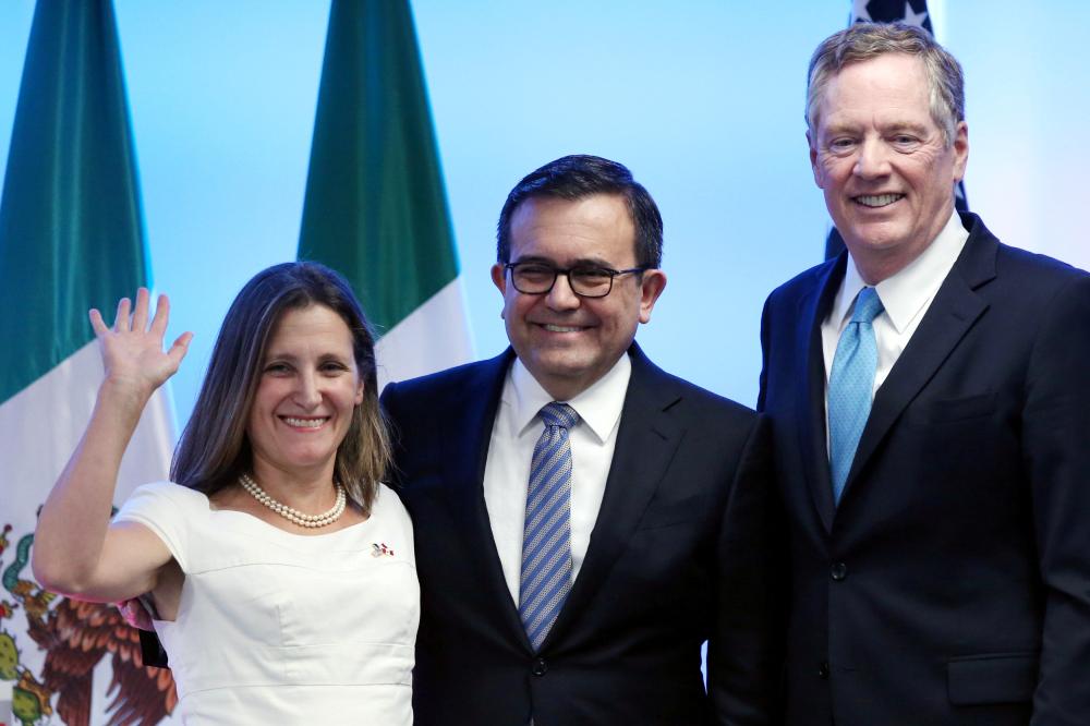 Canadian Foreign Minister Chrystia Freeland, Mexico's Economy Minister Ildefonso Guajardo and US Trade Representative Robert Lighthizer smile as they pose for a photo after addressing the media to close the second round of NAFTA talks involving the United States, Mexico and Canada at Secretary of Economy headquarters in Mexico City, Mexico. — Reuters
