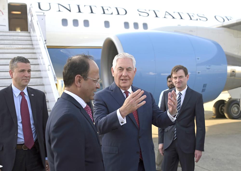 US Secretary of State Rex Tillerson, left, chats with Pakistani foreign office official Sajid Bilal, second left, on his arrival to Pakistan's Nur Khan military airbase in Islamabad, Pakistan, Tuesday. — AP