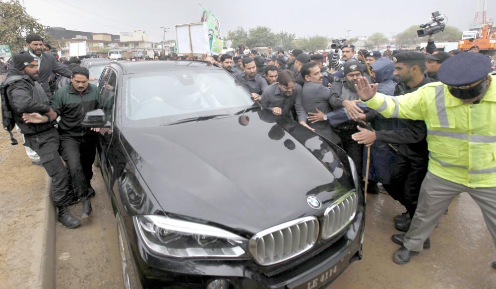 Police officers make way for a car carrying Pakistan’s ousted Prime Minister Nawaz Sharif arriving to appear in an accountability court in Islamabad, Pakistan, on Wednesday. — AP