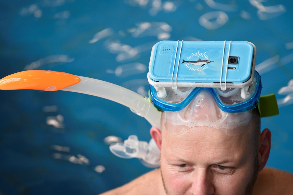 A therapist tests out new cutting-edge waterproof virtual reality glasses playing a film of dolphins, at the 'S Heeren Loo care center for disabled people in Apeldoorn, eastern Netherlands. Swimming with wild dolphins is something most can only dream of, and jumping into pools with captive animals has become increasingly controversial with environmentalists slamming it as cruel. But the Dolphin Swim Club, a Dutch non-profit, believes it has found a way to bring people, especially the disabled, closer to such a joyful experience through the technological, immersive advances offered by virtual reality (VR). - AFP