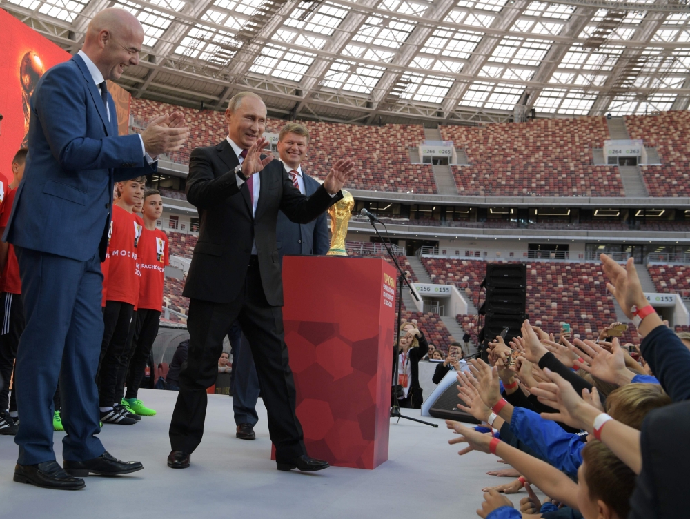 This file photo shows FIFA President Gianni Infantino (L) and Russian President Vladimir Putin (R) smiling during the opening of the trophy tour ceremony at Luzhniki stadium in  Moscow. Russia is gearing up to host the World Cup for the first time while facing the herculean task of eradicating racism and hooliganism and warding off the threat of a terror attack. — AFP