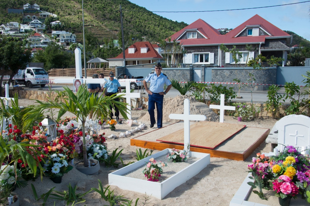 French gendarmes stand by as final preparations are made on Tuesday at the cemetery in Lorient, on the French Caribbean island of Saint Barthelemy, where late French singer Johnny Hallyday was buried. - AFP