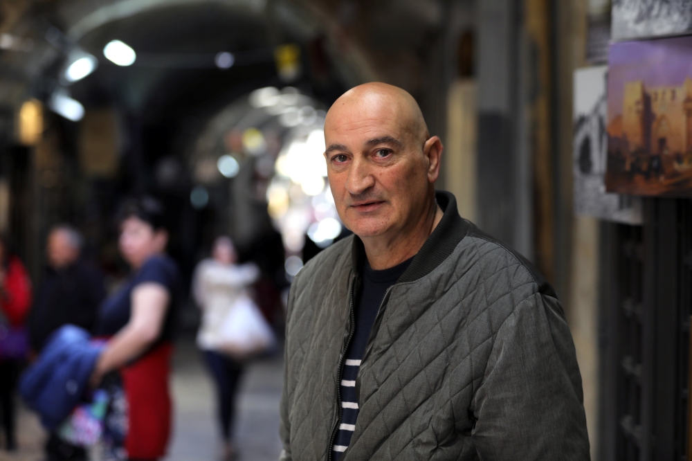 Fredrick Hazo, 59, poses for a photograph during his interview in an alley of Jerusalem's Old City. — Reuters