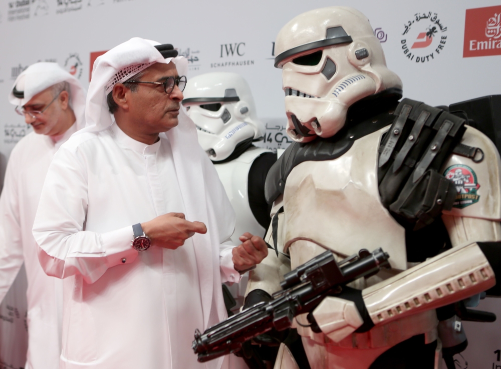 Syrian actress Nesrine Tafesh poses with a Star Wars character as she arrives on the red carpet during the closing ceremony of the Dubai International Film Festival, in Dubai on Wednesday. — AFP