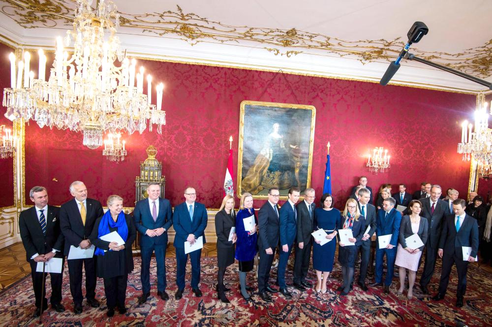 Austrian President Alexander Van der Bellen, eight right, poses with the new appointed Austrian Cabinet during the inauguration ceremony of the new Austrian government at the Hofburg in Vienna, on Monday. — AFP