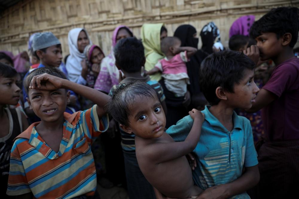 Rohingya refugees wait for food distribution at the Kutupalong refugee camp near Cox's Bazar, Bangladesh December 18, 2017. — Reuters