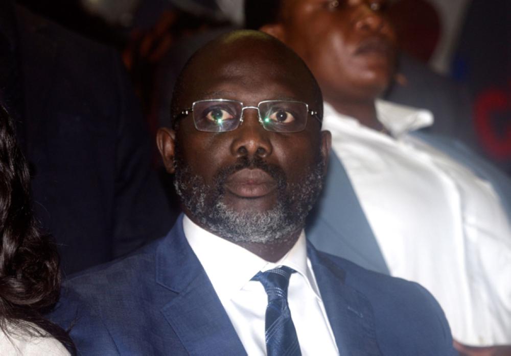 :Former international football star Georges Weah looks on at his party's headquarters in the Liberian capital Monrovia on Friday.  — AFP