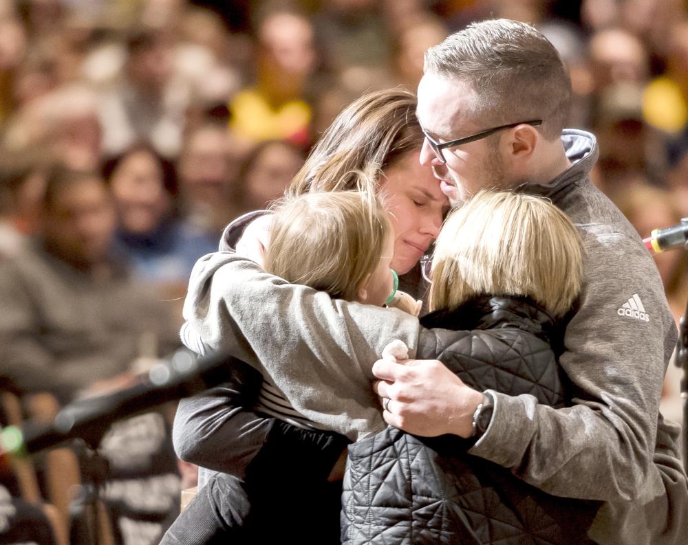 Gracie Zacakri, left, is embraced by her small group as family, friends, and community attended a remembrance and candlelight vigil for Deputy Zackari Parrish at Mission Hills Church in Littleton, Colorado. on Monday. — AP