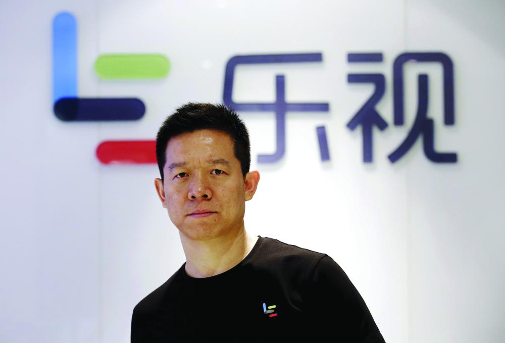 ia Yueting, co-founder and head of Le Holdings Co Ltd, also known as LeEco and formerly as LeTV, poses for a photo in front of a logo of his company at LeEco headquarters in Beijing, China in this file photo. — Reuters