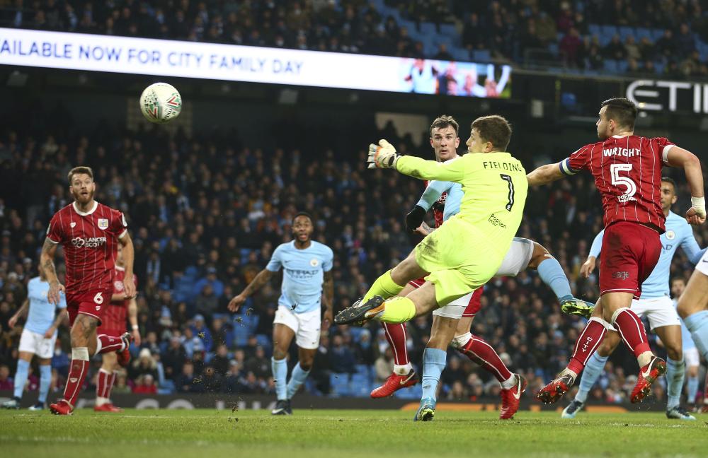 Bristol City's goalkeeper Frank Fielding watches as a ball from Manchester City's Sergio Aguero heads towards the goal during the English League Cup semifinal first leg soccer match between Manchester City and Bristol City at the Etihad stadium in Manchester, England, Tuesday, Jan. 9, 2018. (AP Photo/Dave Thompson)