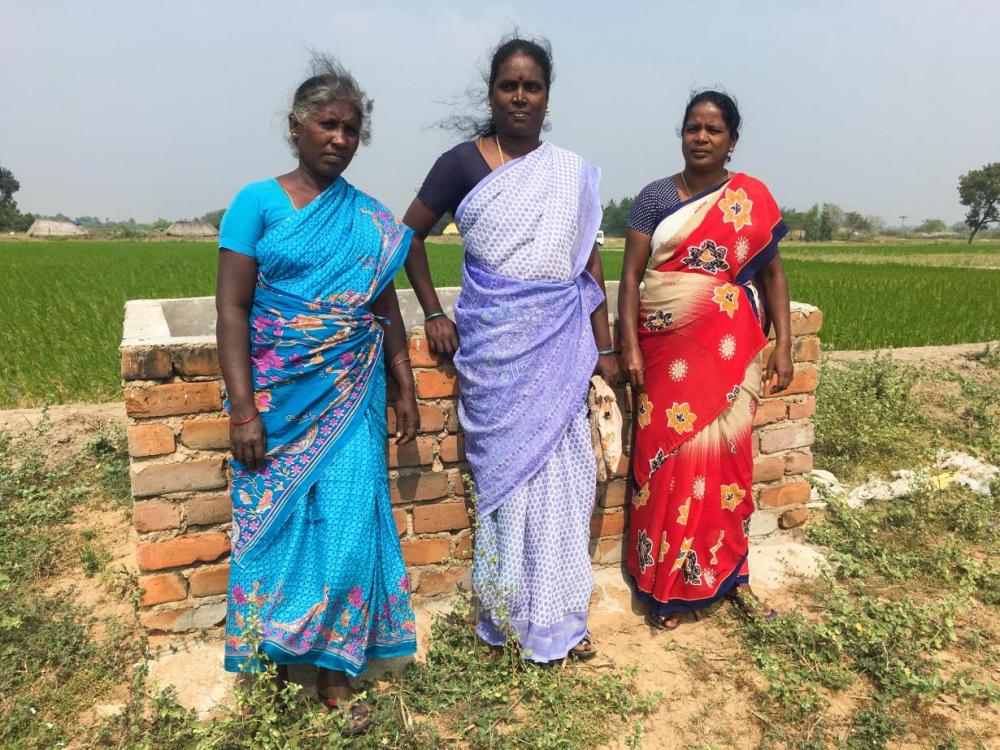 A group of Dalit women of a farming collective stand on the land that they took over for cultivation in Pallur, India. - Thomson Reuters Foundation