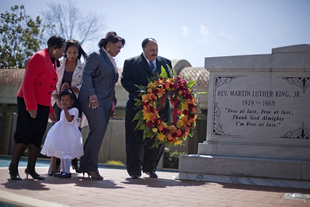 In this file photo, Martin Luther King III, right, the son of Rev. Martin Luther King Jr., lays a wreath at the crypt of his father along with from right, Rev. King's daughter, Rev. Bernice King, granddaughter Yolanda, 2, her mother Arndrea King, and Christine King Farris, sister of Dr. King Jr., on the 43rd anniversary of his assassination in Atlanta. — AP