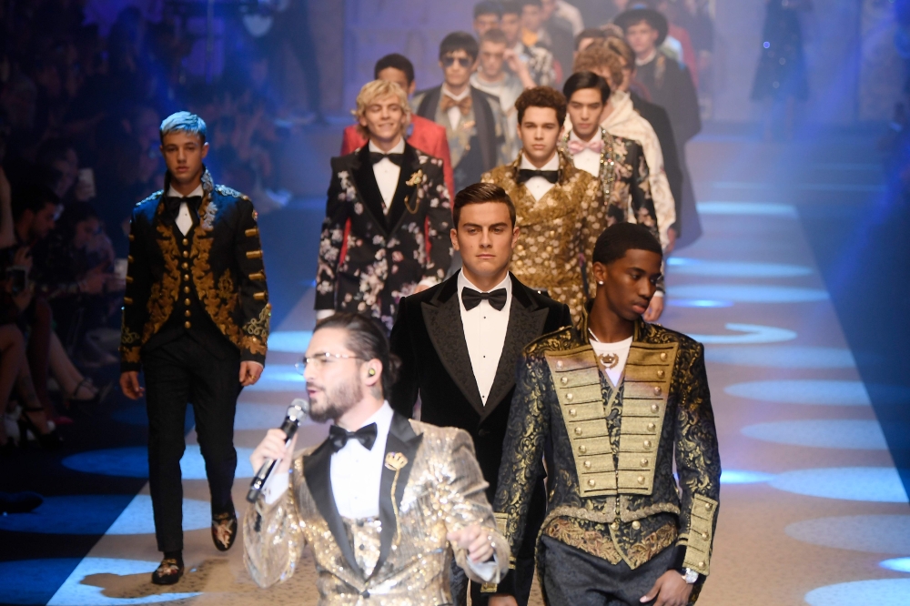 Models and Juventus' forward from Argentina Paulo Dybala, center, present creations for fashion house Dolce & Gabbana during the Men's Fall/Winter 2019 fashion show in Milan on Sunday. - AFP
