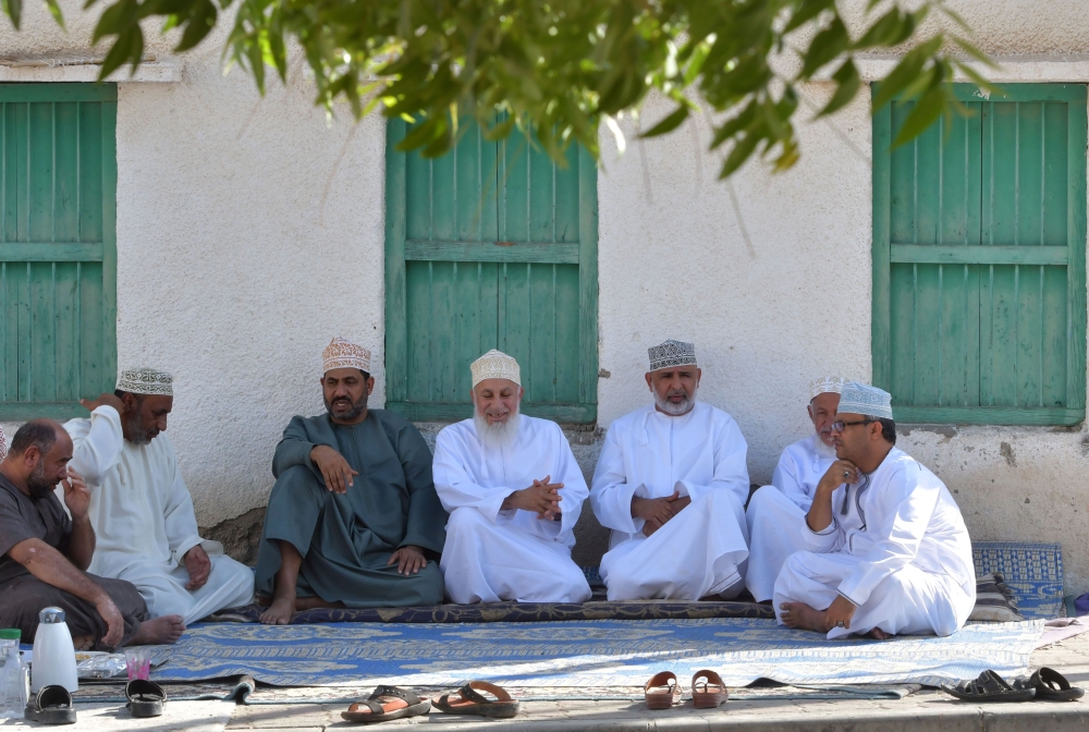 Omani men chat in the small village of Ghala, near Muscat. The men in Ghala village gather each Friday for the 