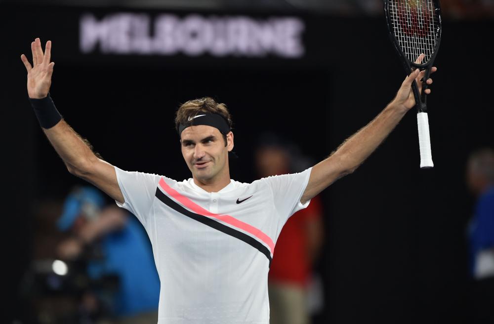Switzerland’s Roger Federer celebrates after beating Slovenia’s Aljaz Bedene at the Australian Open in Melbourne Tuesday. — AFP
