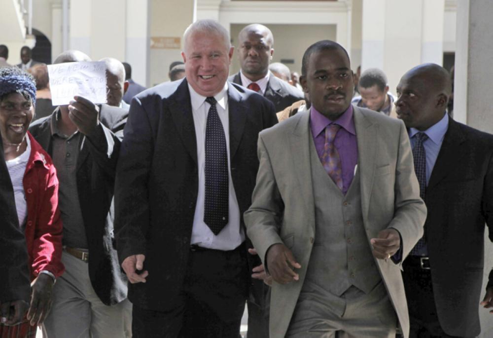 File Photo: May 2010,  Roy Bennett, center left, leaves the High Court in Harare, Zimbabwe, after he was acquitted of terrorism charges.— AP