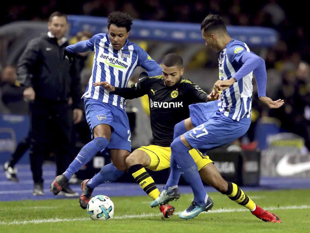 Hertha’s Valentino Lazaro (L) and Davie Selke (R) challenge for the ball with Dortmund’s Jeremy Toljan (C) during their German Bundesliga soccer match in Berlin Friday. — AP