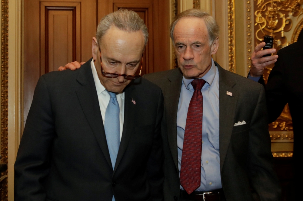 Senator Tom Carper (D-DE) (R) talks to Senate Minority Leader Chuck Schumer (D-NY) as they leave the Democratic Party caucus meeting on Capitol Hill in Washington, US, Friday. — Reuters
