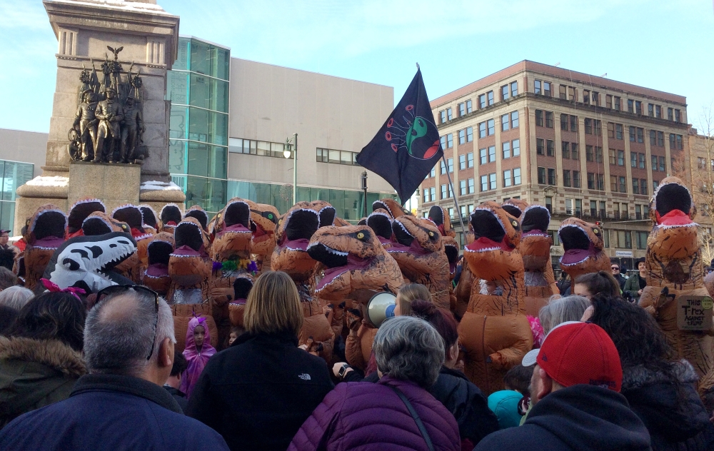 People dressed in inflatable Tyrannosaurus rex dinosaur costumes participate in a rally in Portland, Maine on Sunday. - AP