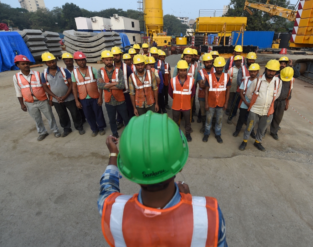 This picture shows workers listening to safety instructions during a briefing at the start of their shift at a metro railway working site in Mumbai. The new underground metro is expected to ease the burden on Mumbai's notoriously congested roads and railways, but not everybody in India's sprawling financial capital is happy about the multi-billion-dollar project. — AFP