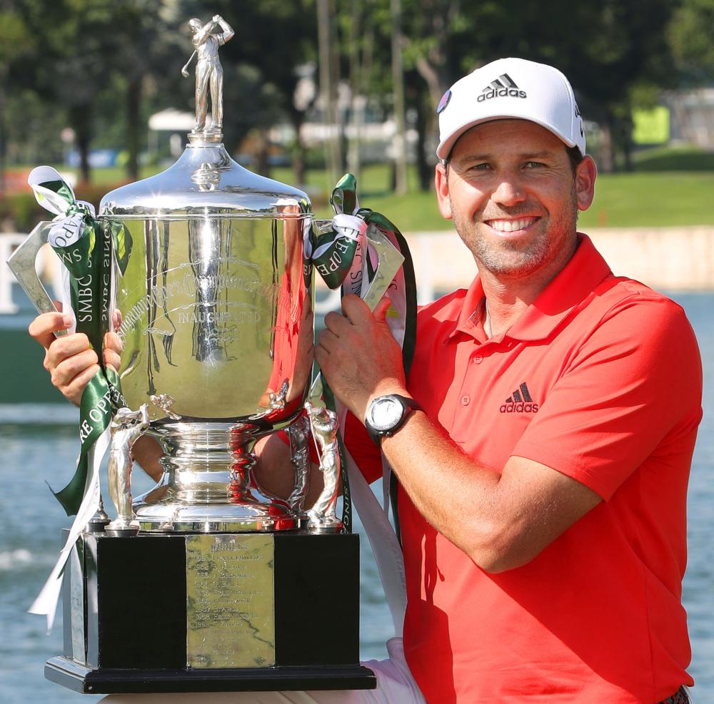 Spain’s Sergio Garcia poses with his trophy after wining the Singapore Open Golf Tournament at the Sentosa Golf Club Sunday. — AP