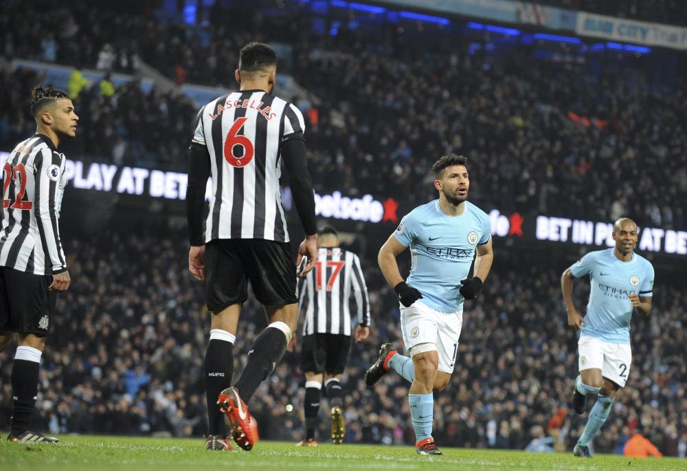 Newcastle players, at left, react after Manchester City’s Sergio Aguero (2nd R) scored his side’s third goal during their English Premier League match at the Etihad Stadium in Manchester Saturday. — AP