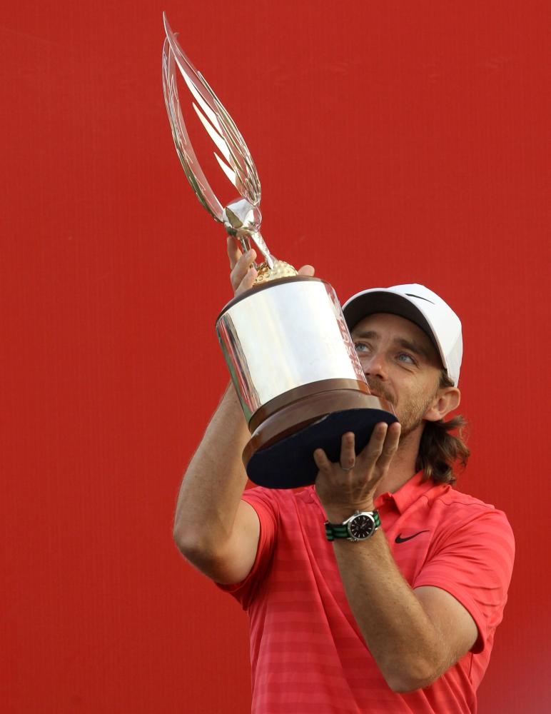 England's Tommy Fleetwood poses with the Abu Dhabi HSBC Championship trophy at Abu Dhabi Golf Club Sunday. — Reuters