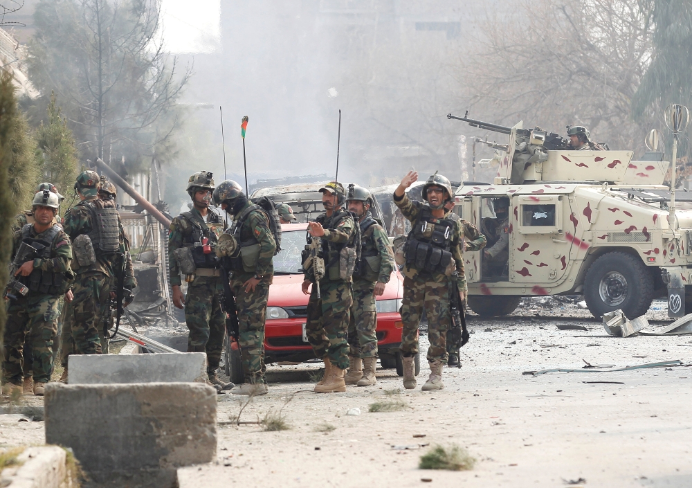 Afghan security forces arrive at the site of a blast and gun fire in Jalalabad, Afghanistan, on Wednesday. — Reuters