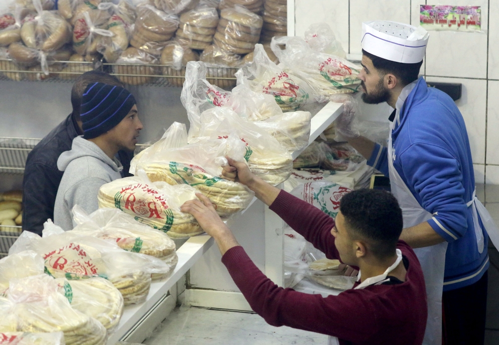 Jordanians buy bread from a bakery in Amman. Jordan's Minister of Industry announced the decision to raise the price of bread in all its local varieties as of Saturday. — AFP