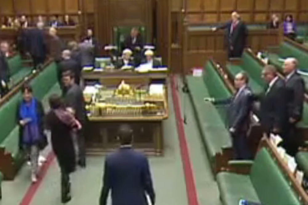 A video grab taken on Feb. 1, 2017 from footage broadcast by the UK Parliament’s Parliamentary Recording Unit (PRU) shows Conservative MP Chloe Smith, left, walking to vote in the commons holding her baby. — AFP