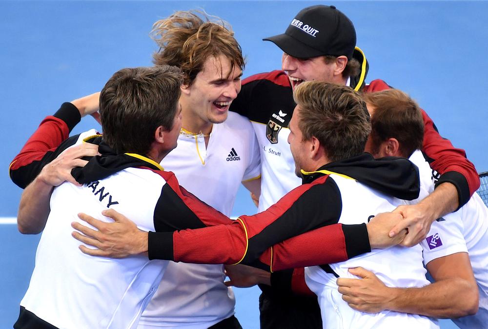 Germany’s Alexander Zverev celebrates with teammates after defeating Australia’s Nick Kyrgios during their Davis Cup tennis World Group first round match at Pat Rafter Arena in Brisbane Sunday. — AFP