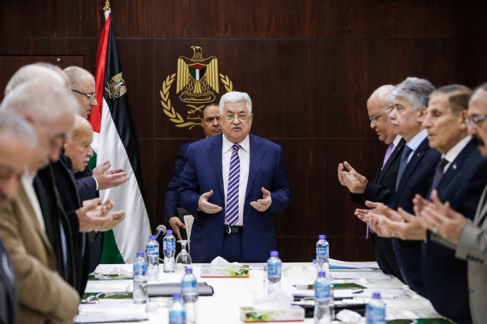 Palestinian President Mahmoud Abbas recites a prayer prior to chairing a meeting of the Palestine Liberation Organization (PLO) Executive Committee at the Palestinian Authority headquarters in the West Bank city of Ramallah, discussing recommendations to suspend the PLO's recognition of Israel in response to US President Donald Trump's declaration of Jerusalem as Israel's capital. — AFP