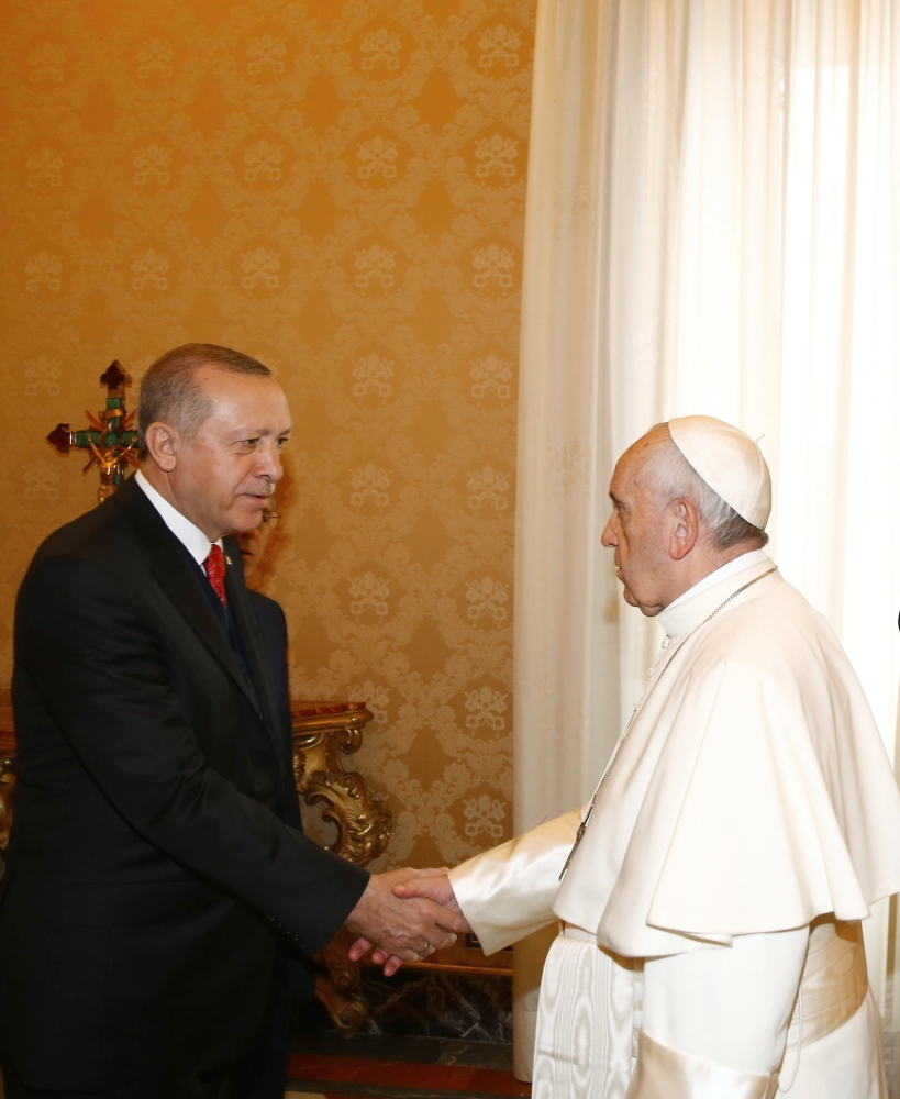 Turkish President Recep Tayyip Erdogan (L) shakes hands with Pope Francis (R) prior to their meeting in Vatican City on Monday. — AFP