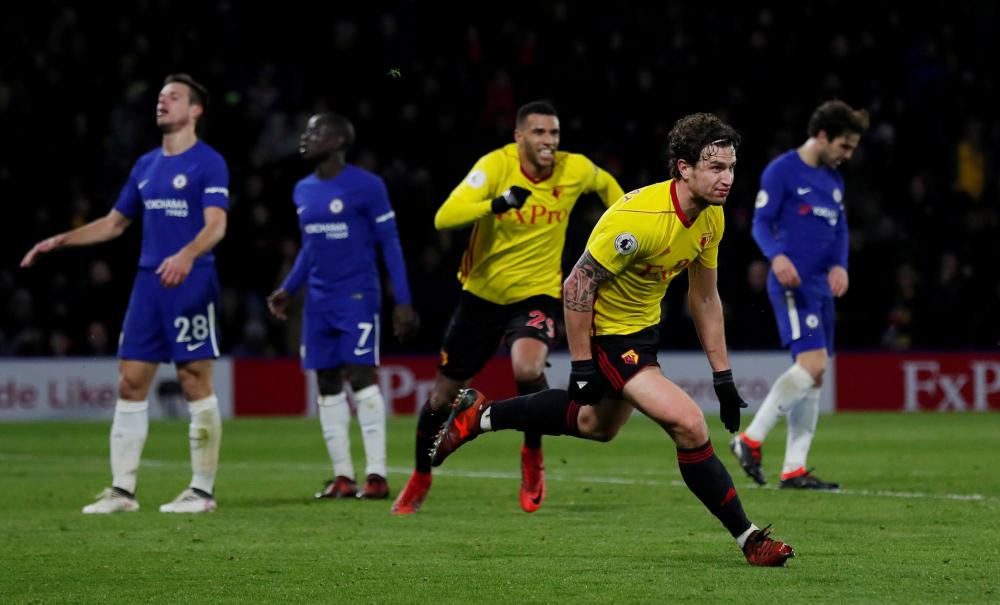 Watford’s Daryl Janmaat celebrates scoring their second goal against Chelsea during their Premier League match at Vicarage Road, Watford, Monday. — Reuters