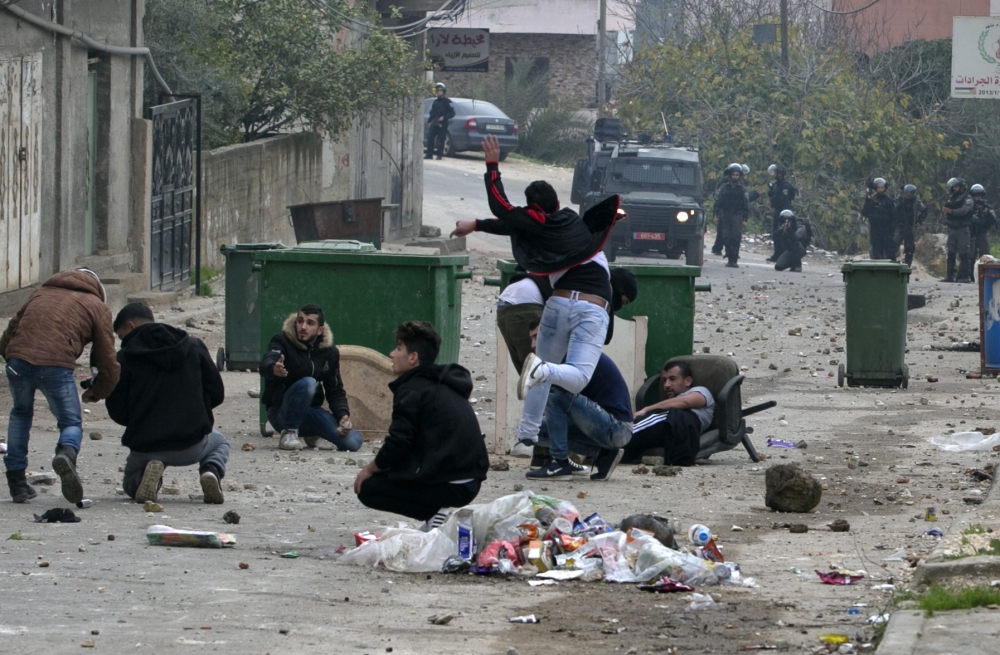 Palestinian youths clash with Israeli forces in the village of Yamoun, on the outskirts of Jenin, in the occupied West Bank on Tuesday following an operation by the Israeli army. — AFP