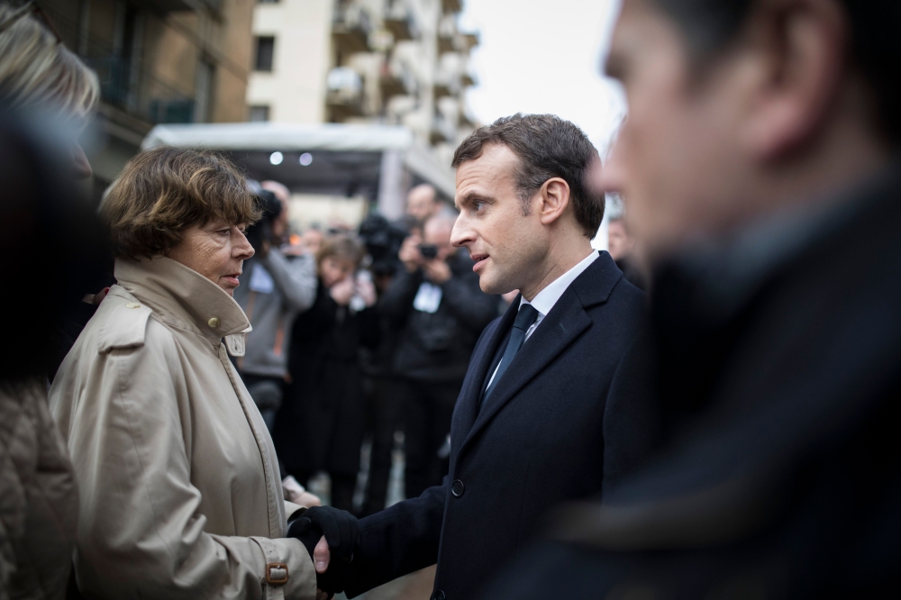 French President Emmanuel Macron speaks with people after the ceremony to unveil the square plaque in tribute to slain French prefect Claude Erignac, in Ajaccio, on the French Mediterranean island of Corsica, on Tuesday. — AFP
 