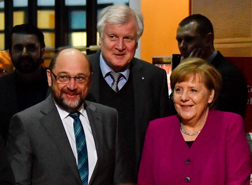 German Chancellor and leader of the Christian Democratic Union (CDU) Angela Merkel, right, the leader of the Social Democratic Party (SPD) Martin Schulz, left, and the chairman of the Bavarian Christian Social Union (CSU) Horst Seehofer, center, enter the conference room at the headquarters of Social democrats Party (SPD) for coalition talks to form a new government in Berlin in this Feb. 2, 2018 file photo. — AFP