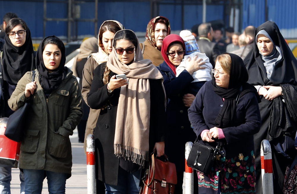 Iranian women wearing hijab walk down a street in the capital Tehran. A spate of unprecedented protests against Iran's mandatory headscarves for women have been tiny in number, but have still reignited a debate that has preoccupied the republic since its founding. — AFP