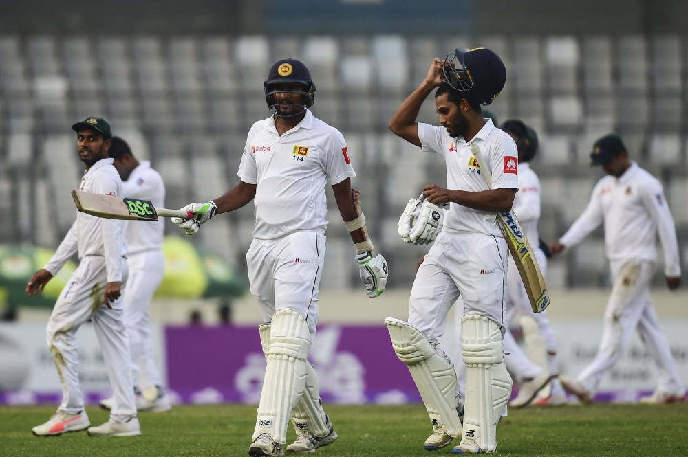 Sri Lanka cricketers Suranga Lakmal (L) and Roshen Silva (R) walk off the field after the second day of the second cricket Test between Bangladesh and Sri Lanka at the Sher-e-Bangla national cricket stadium in Dhaka on Friday. — AFP