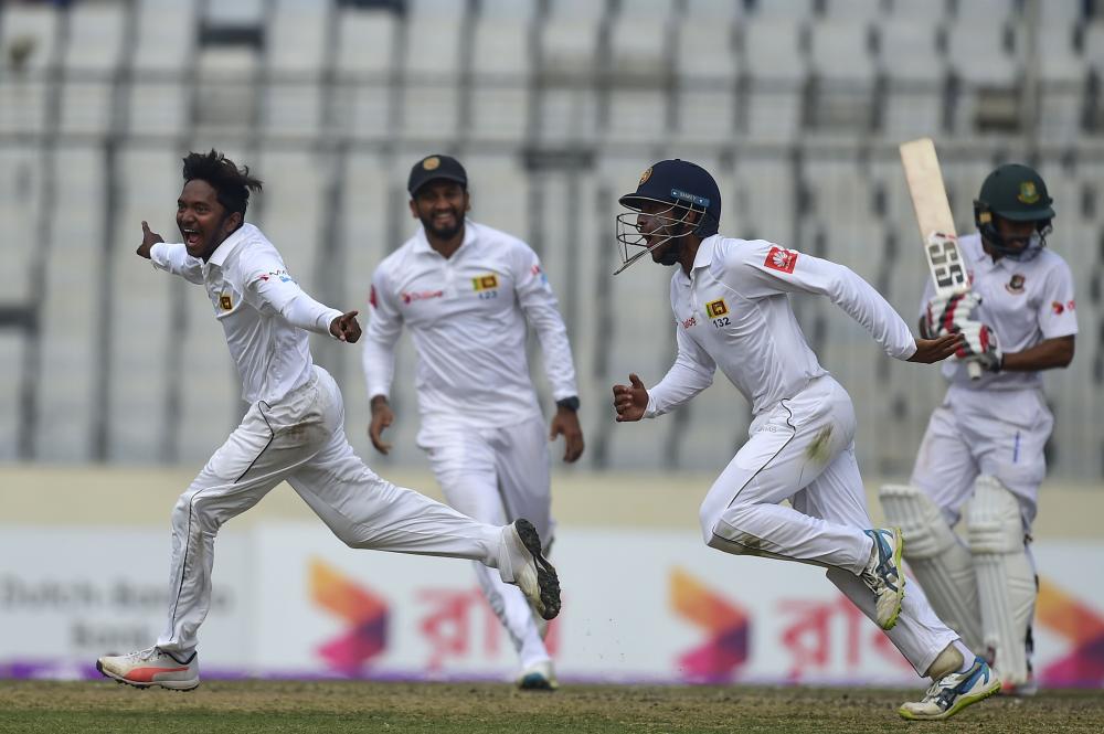 Sri Lanka cricketer Akila Dananjaya (L) celebrates after taking the wicket of Bangladesh’s Mehedi Hasan during the third day of the second cricket Test match at the Sher-e-Bangla National Cricket Stadium in Dhaka Saturday. — AFP