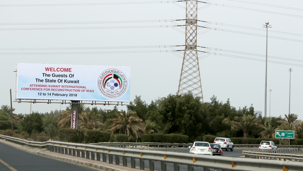 A picture shows a billboard along a highway in the capital Kuwait City welcoming guests participating in the Kuwait International Conference for Reconstruction of Iraq.  — AFP