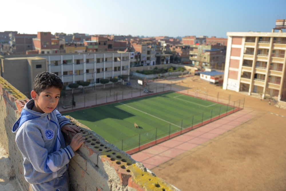 An Egyptian boy stands near the school campus where Egyptian footballer Mohamed Salah, Liverpool's top scorer and Africa's top player, studied in the village of Nagrig, about 120 kilometres northwest of Cairo. — AFP
