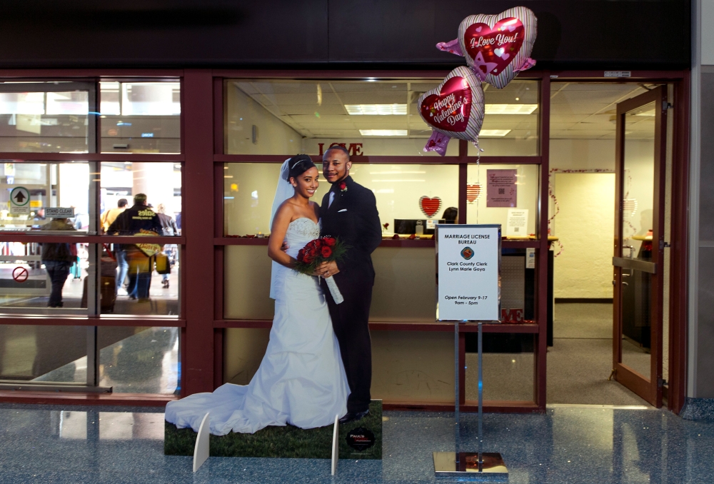 A newly-wed couple is seen outside a temporary pop-up marriage license office at McCarran International Airport in Las Vegas on Tuesday. The Las Vegas airport has given new meaning to rushing to make a connection, offering quickie wedding licenses for lovebirds seeking to get hitched on Valentine's Day. - AFP