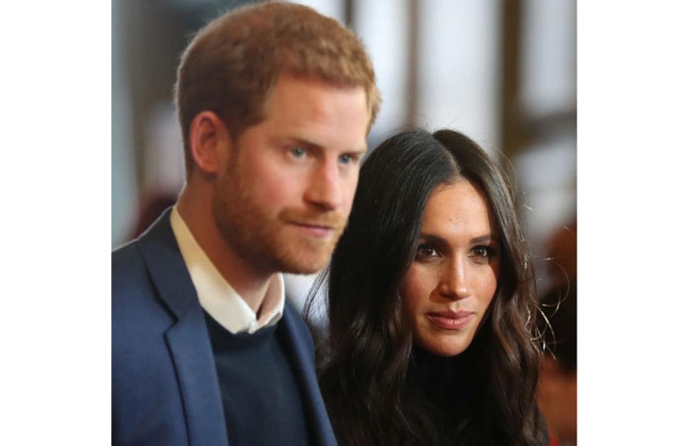 Britain's Prince Harry and his fiancee Meghan Markle attend a reception for young people at the Palace of Holyroodhouse in Edinburgh on Wednesday. - Reuters