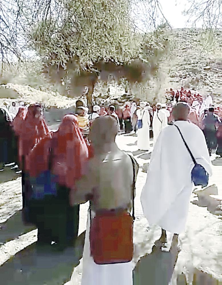 Some pilgrims are seen kissing a tree that they considered to be holy in village in Taif. — Okaz photo