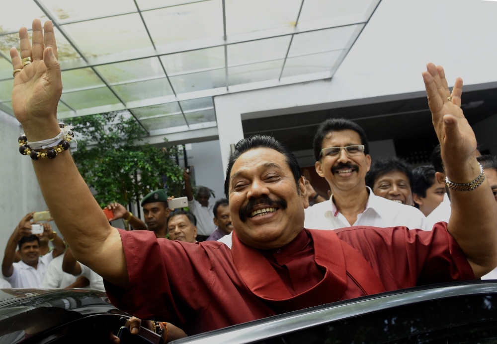 Former Sri Lankan president Mahinda Rajapakse waves to supporters at the party office following a press conference after winning the local government election in the capital Colombo on Monday. — AFP
