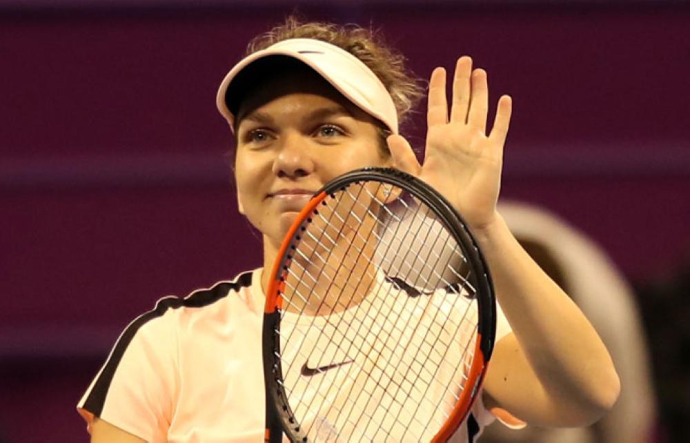 Simona Halep of Romania celebrates after winning her match against Russia’s Ekaterina Makarova at the Qatar Open in Doha Wednesday. — AFP