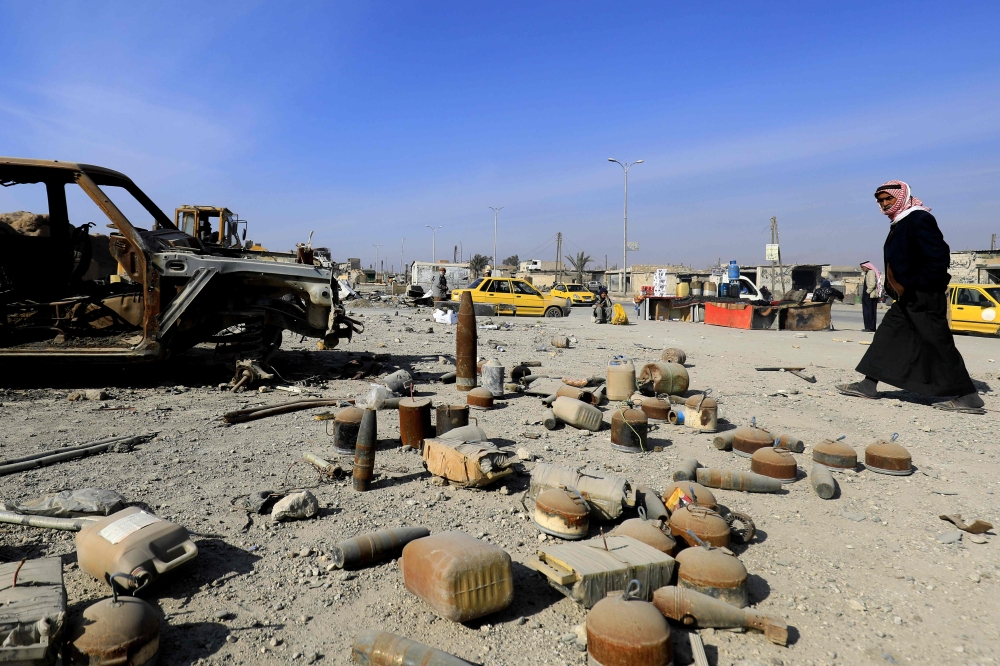 A Syrian man walks past undetonated mines lying on a street in Raqqa that were left by Daesh (the so-called IS) group. The group was ousted from its de facto Syrian capital Raqqa in October, but it left an ocean of mines scattered across the ravaged city. — AFP